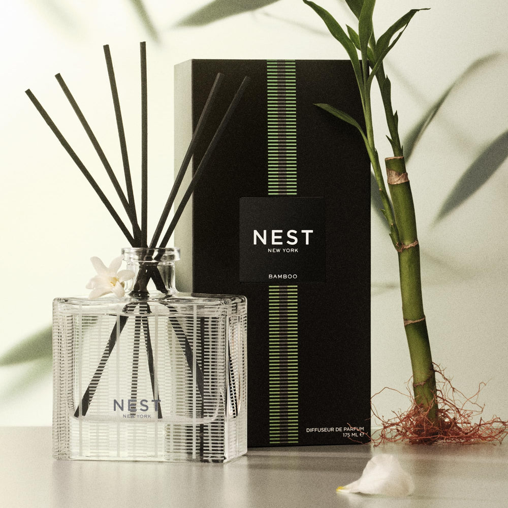 NEST New York fragrance refill bottle beside diffuser demonstrating ease of refilling and continued use