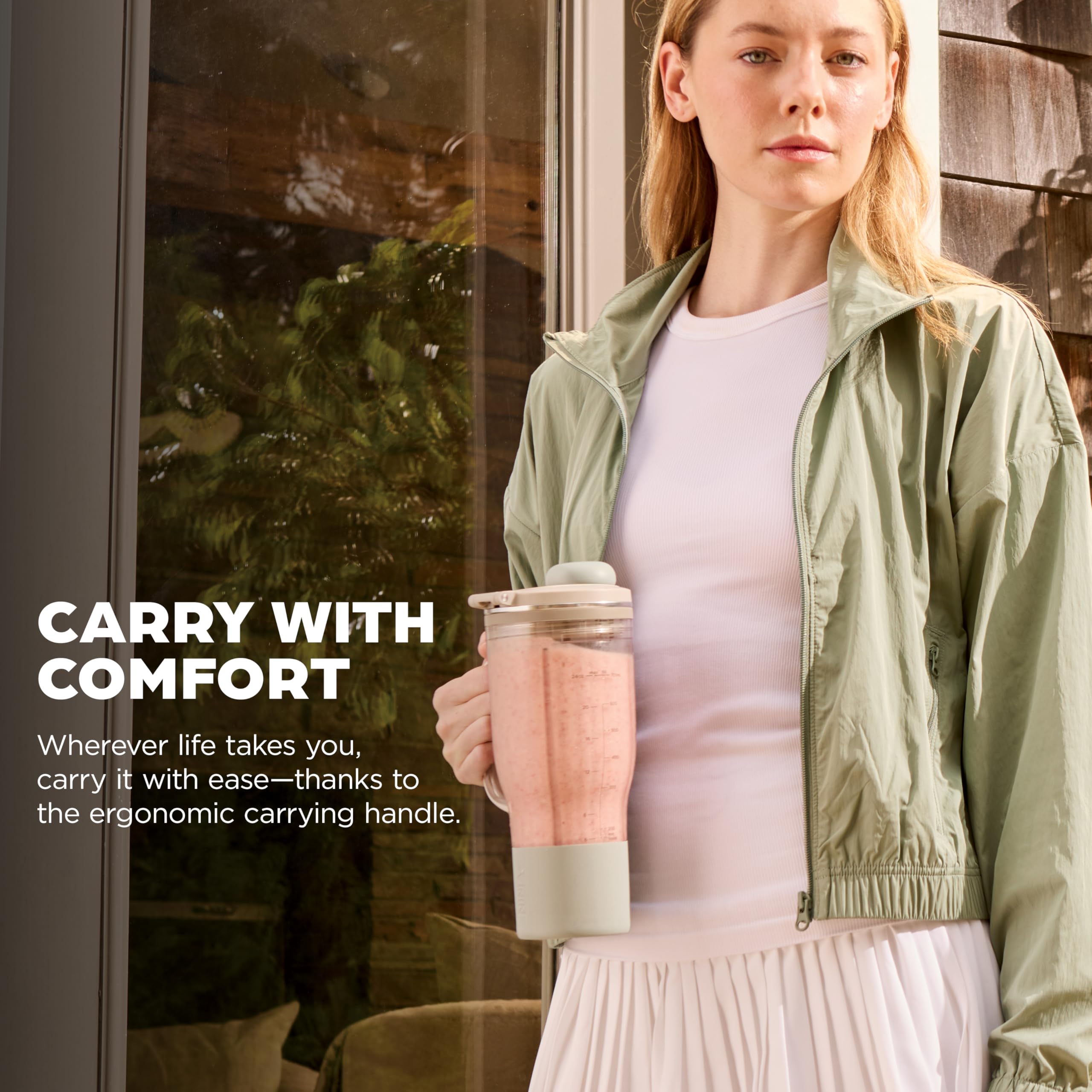 Ninja 26oz tumbler with handle shown against a hand for cupholder-friendly carry benefit