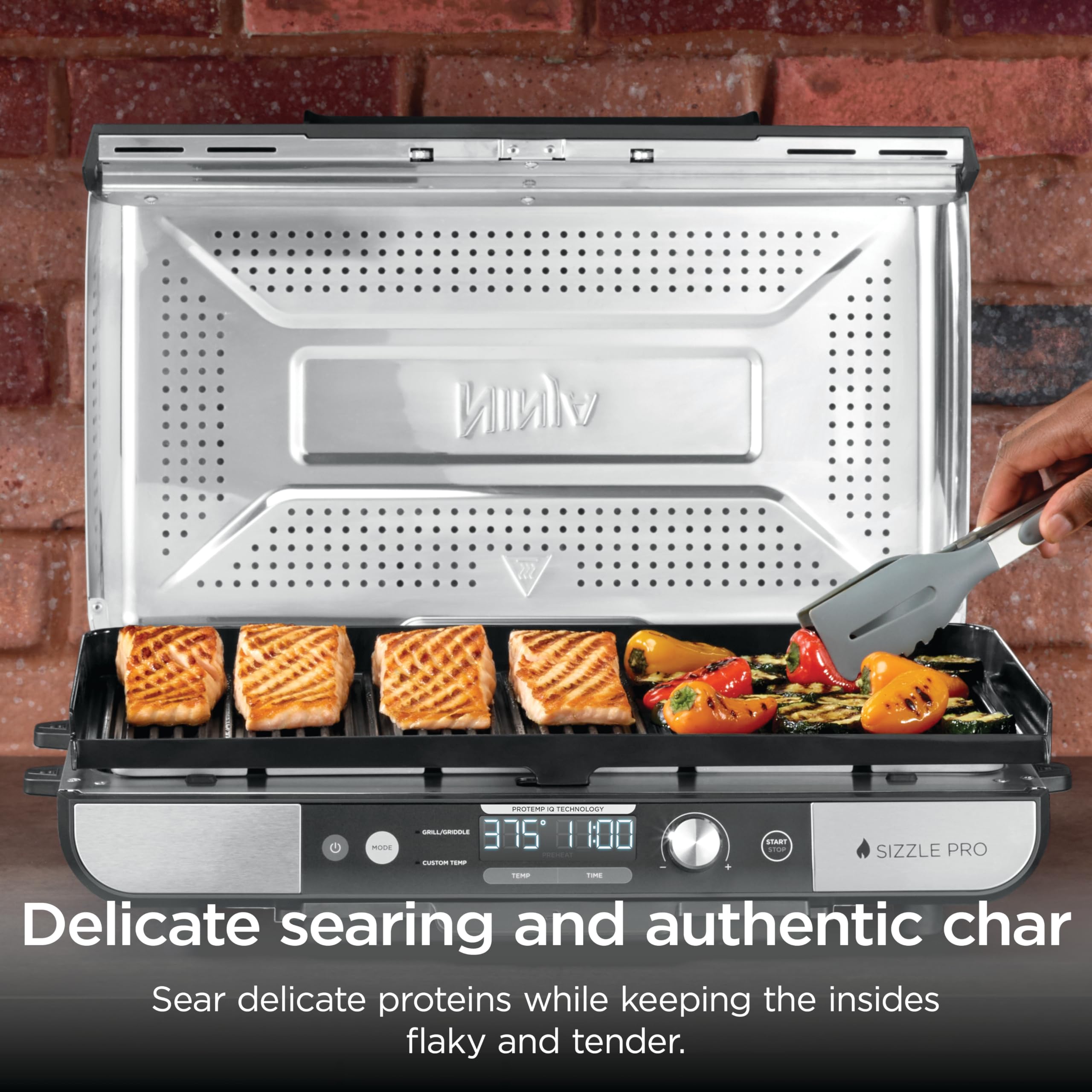 Ninja brand searing steak with lid up showcasing high-heat sear capability