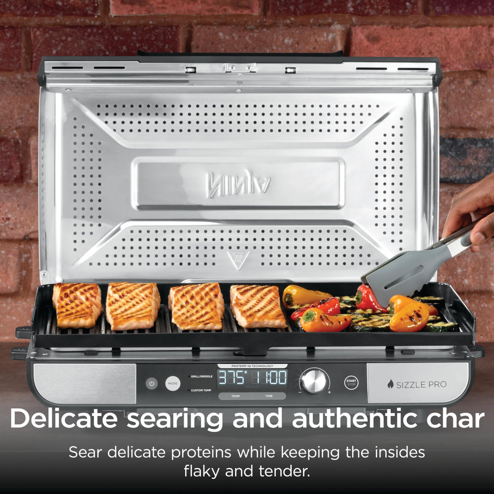 Ninja brand searing steak with lid up showcasing high-heat sear capability