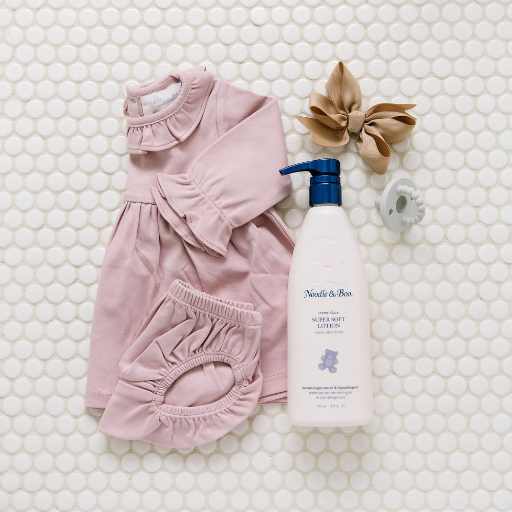 Noodle & Boo silky lotion texture on palm demonstrating quick absorption