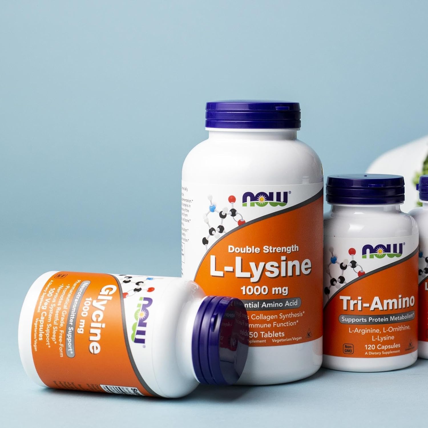NOW glycine capsules spread on table illustrating free-form amino acid consistency
