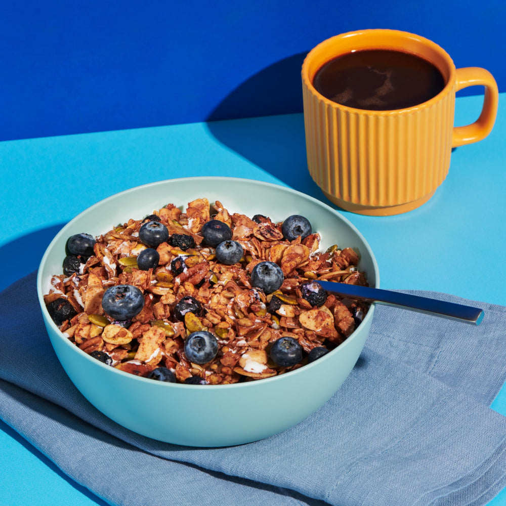 NuTrail resealable pouch in hand for on-the-go low-sugar snacking