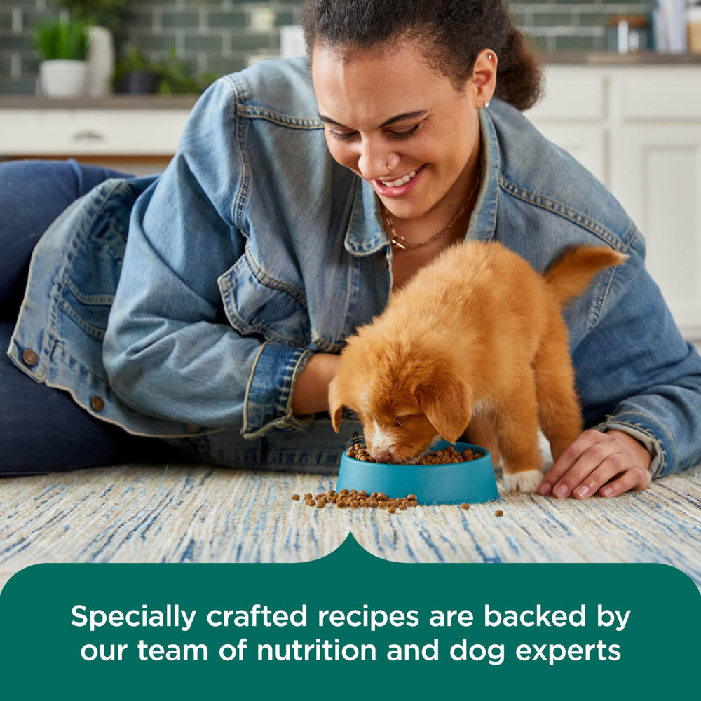 Nutrish bag next to a puppy for scale showing 13 lb volume and value benefit