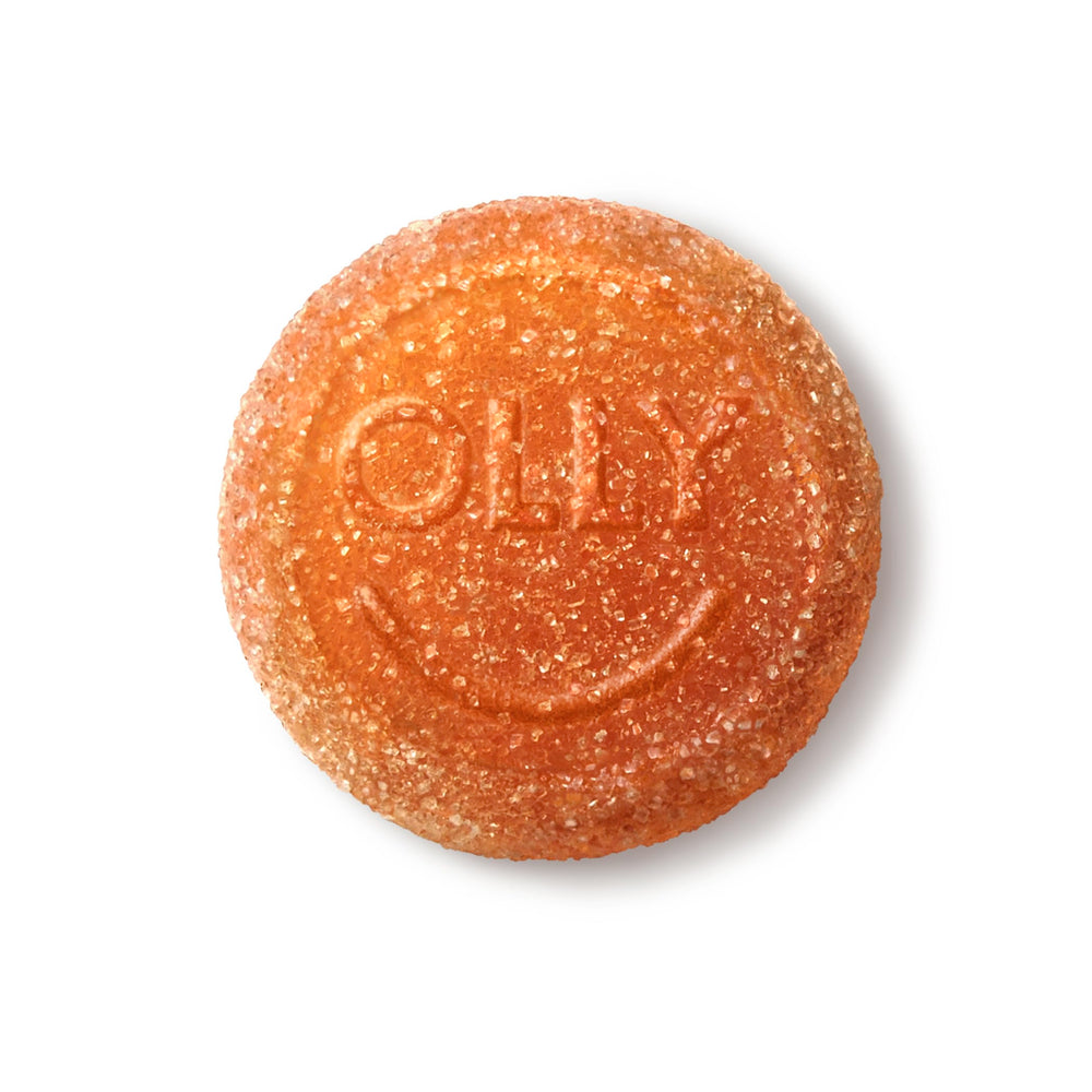 Person chewing gummy with smile, OLLY delivers tasty chewable vitamins daily