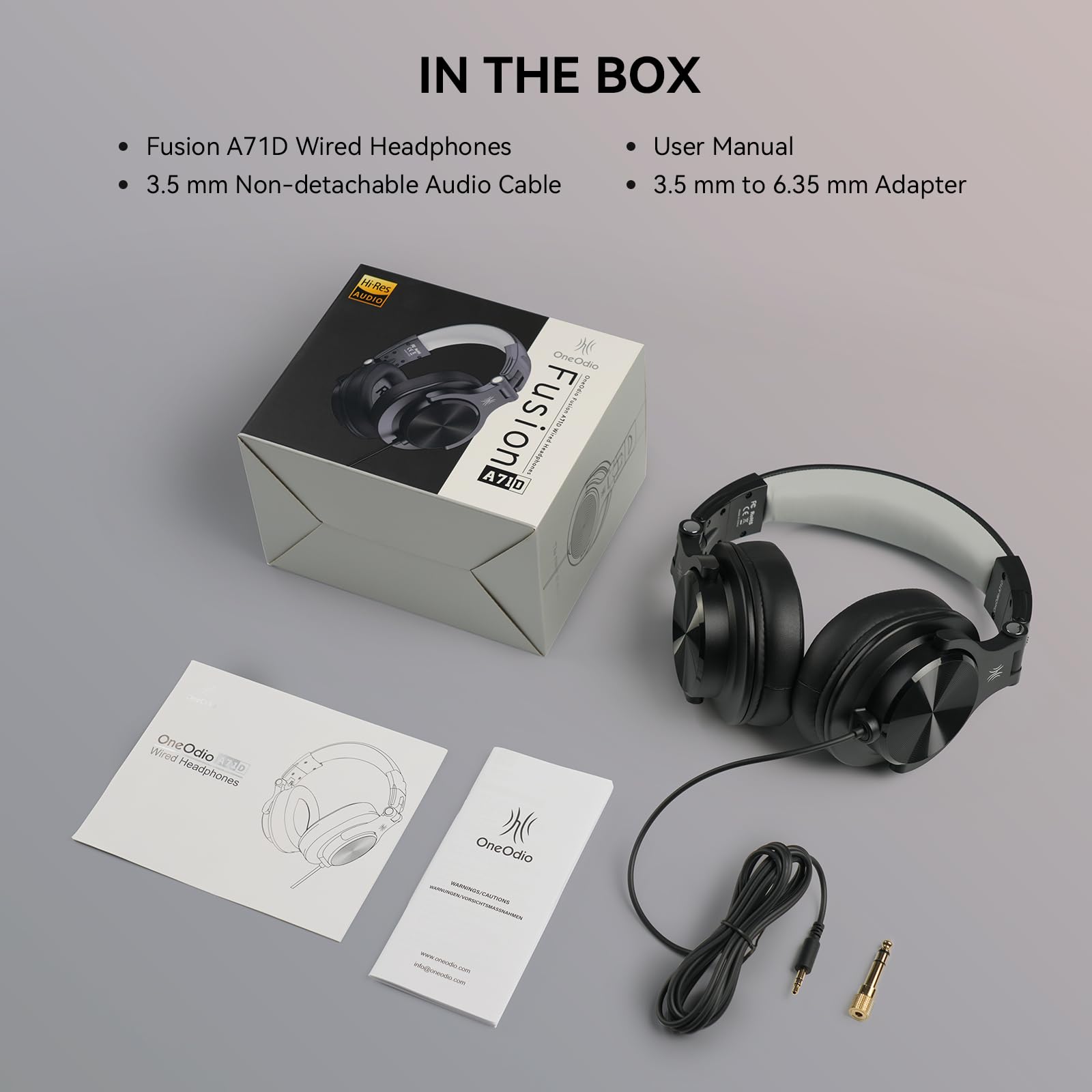 OneOdio A71D on headphones stand beside laptop and mixer for reliable studio monitoring