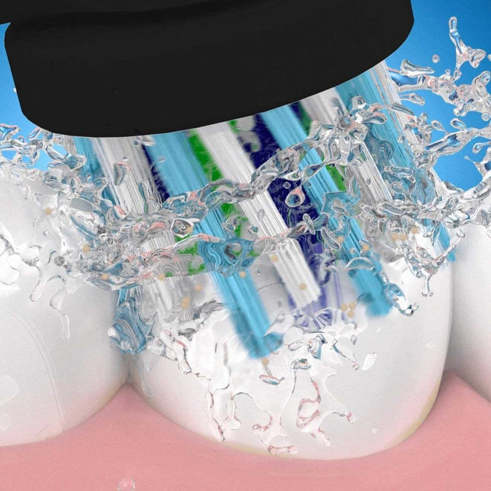 Oral-B CrossAction next to coin for size comparison and compact reach benefit