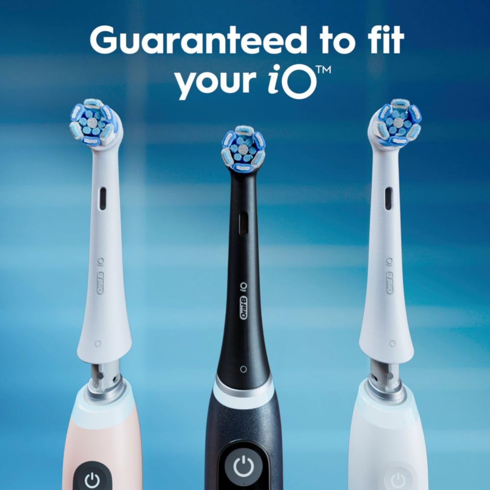 Oral-B brush head next to coin showing scale and compact size benefit