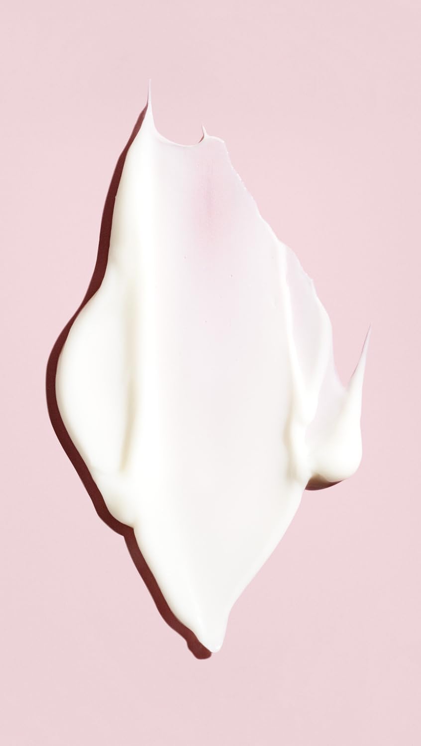 Oribe conditioner applied to damp hair in salon setting demonstrating repair and shine