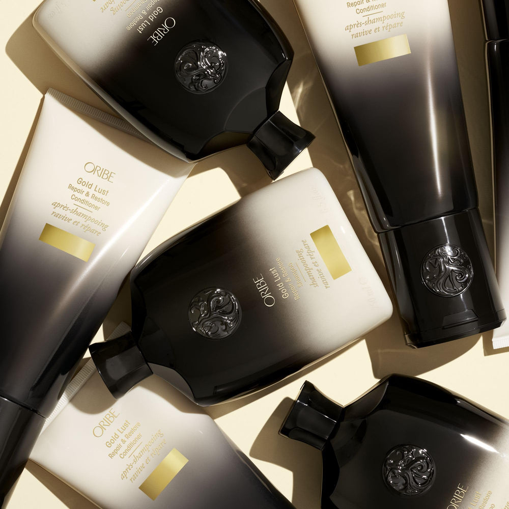 Oribe Gold Lust shampoo in shower scene illustrating salon-quality home treatment