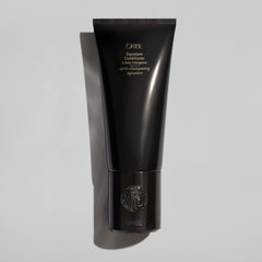 Oribe Signature Conditioner creamy texture close-up showing hydrating consistency