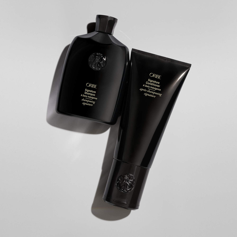 Oribe Signature Conditioner in shower with lathering demonstrating use and slip