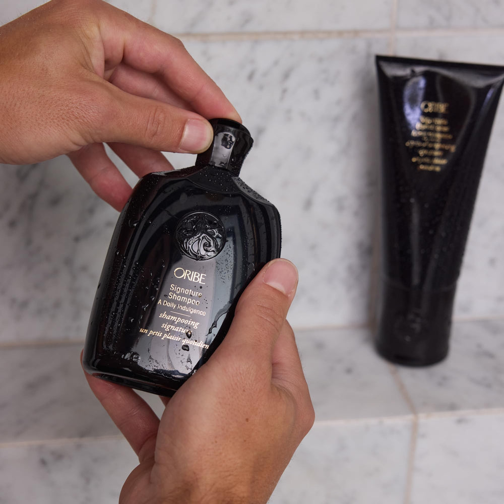 Oribe signature shampoo in-shower use demonstrating smooth application and detangling