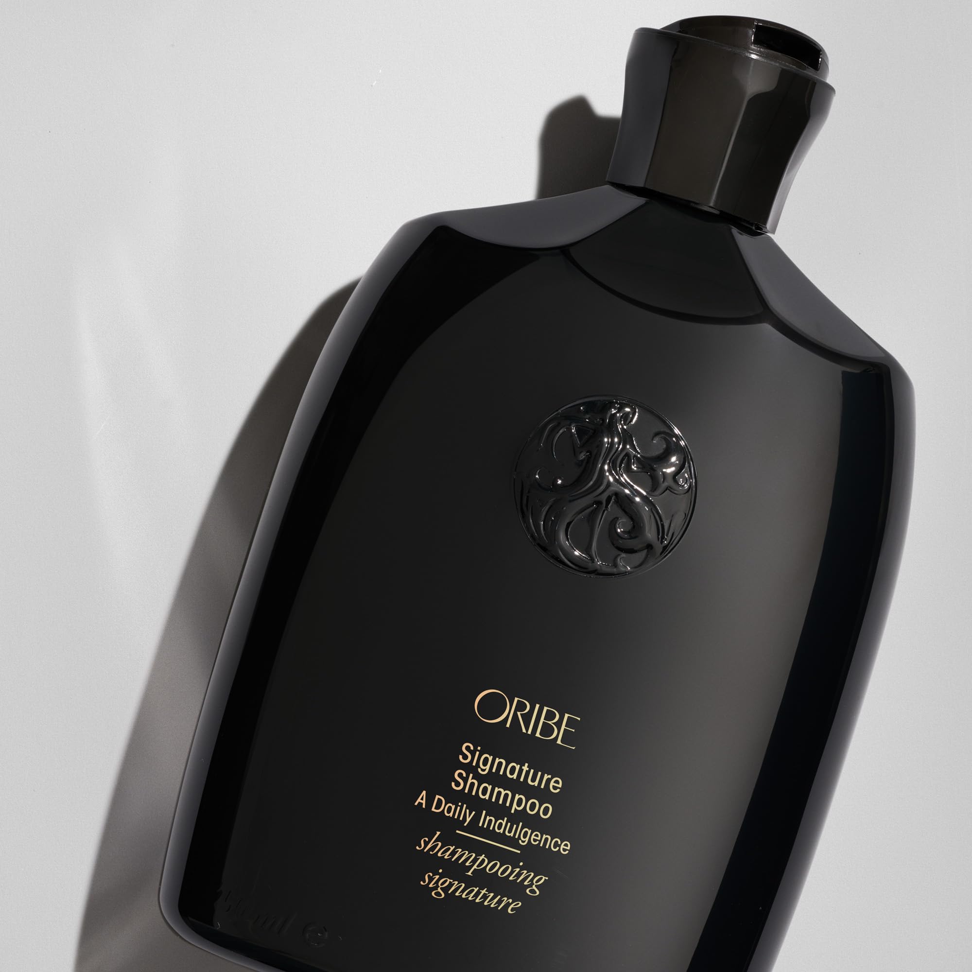 Oribe signature shampoo pump and cap detail for easy daily dispensing
