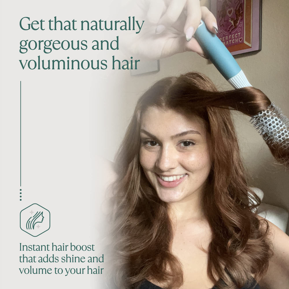 Osensia brush held in hand to show scale and lightweight ergonomic balance