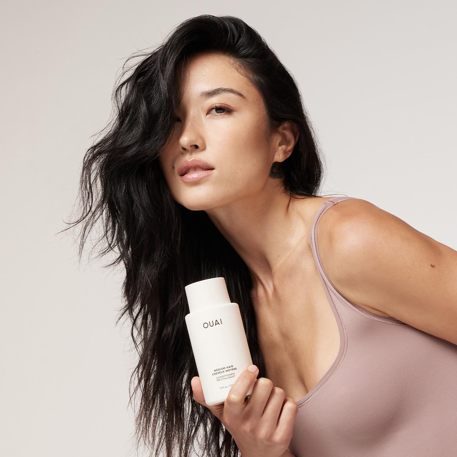 OUAI conditioner cream texture in a jar showing smooth hydrating consistency