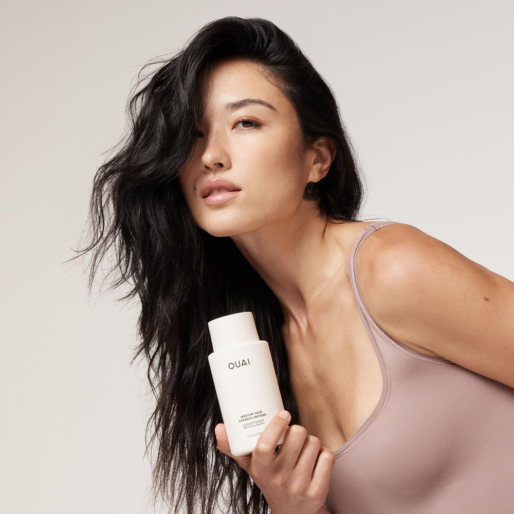 OUAI conditioner cream texture in a jar showing smooth hydrating consistency