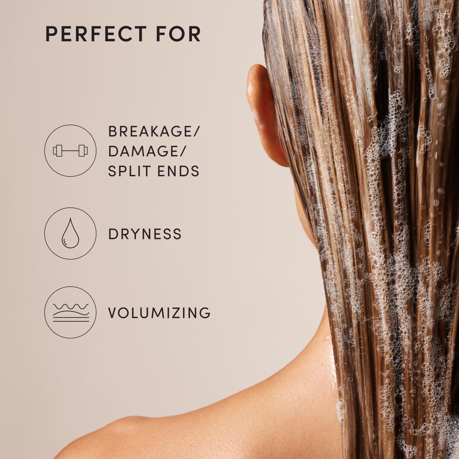 OUAI hand applying shampoo at roots to illustrate lift and targeted volume benefits