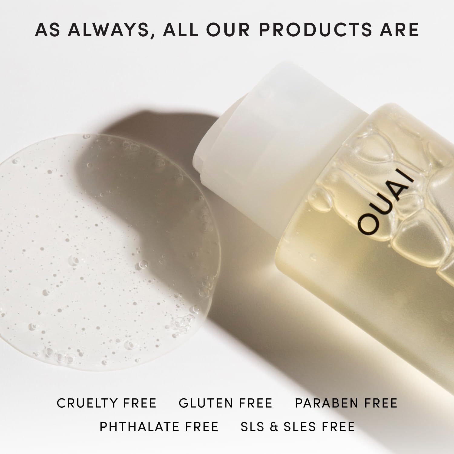 OUAI 10 fl oz bottle beside common items to show size and travel-ready convenience