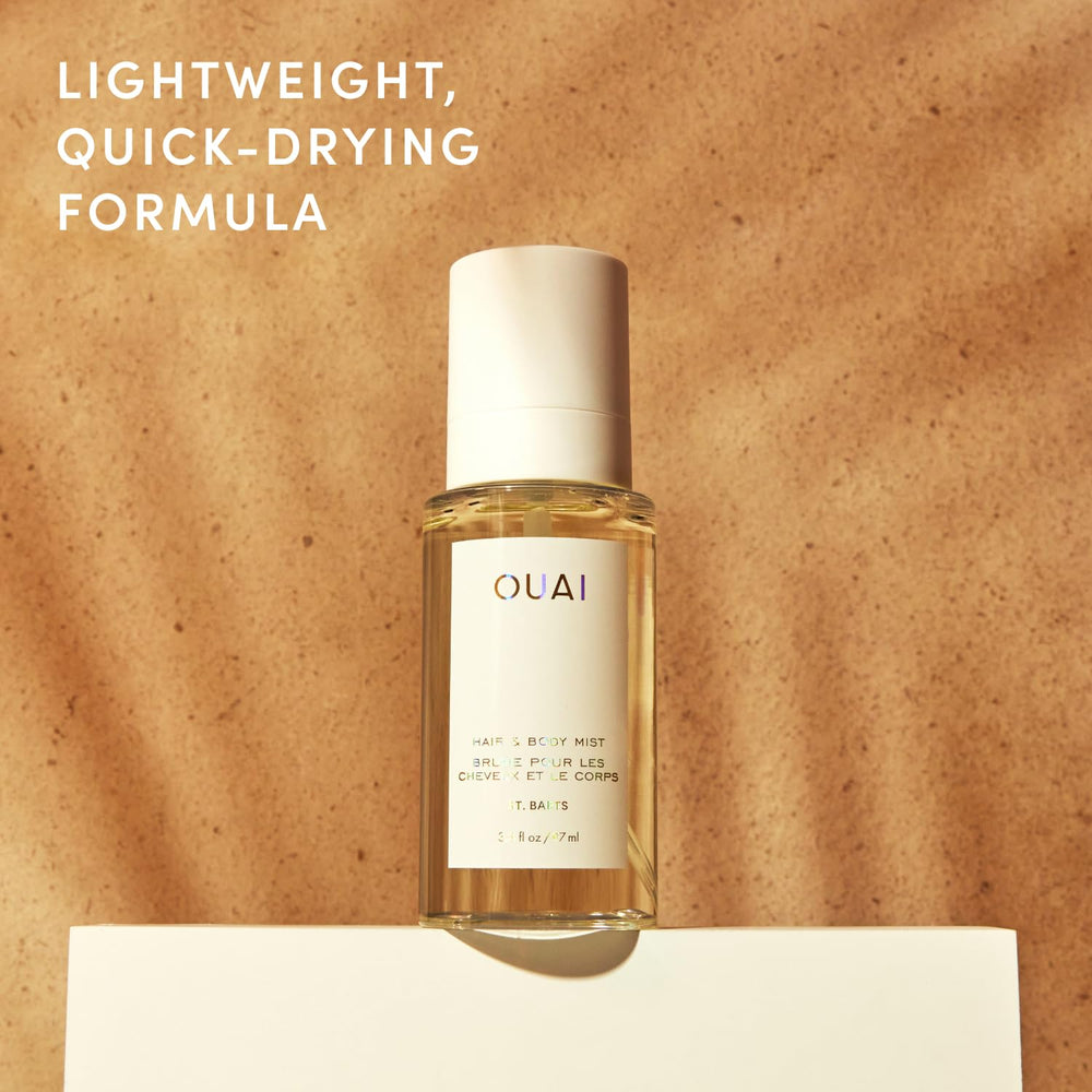 OUAI bottle held in hand showing scale and portable 3.3 oz convenience
