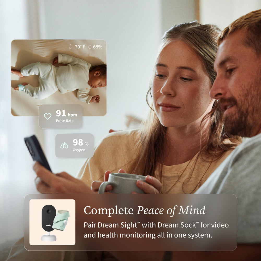Owlet Dream Sight beside smartphone showing scale and remote viewing advantage