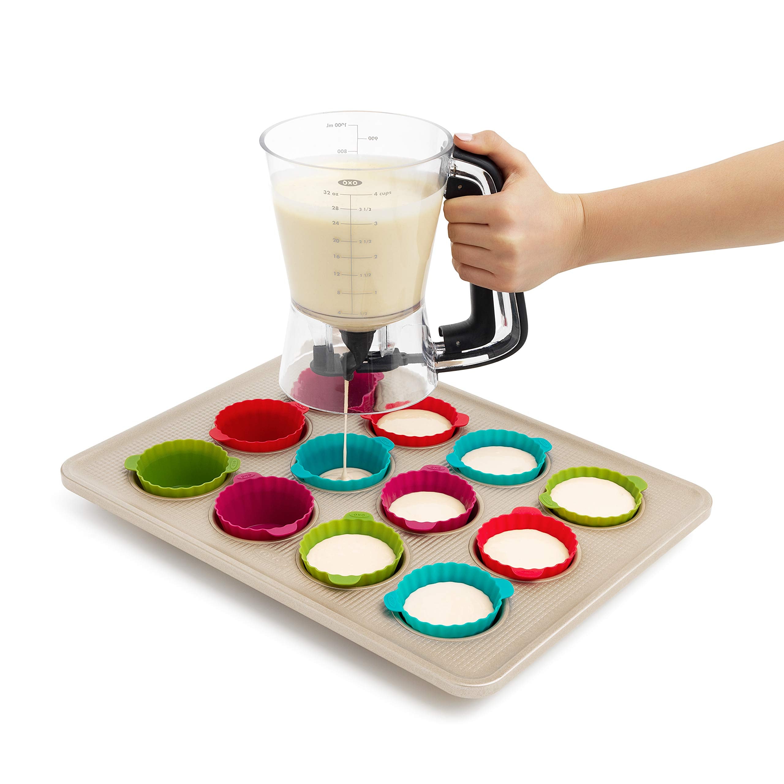 OXO Good Grips held in hand showing comfortable squeeze handle for precise portions