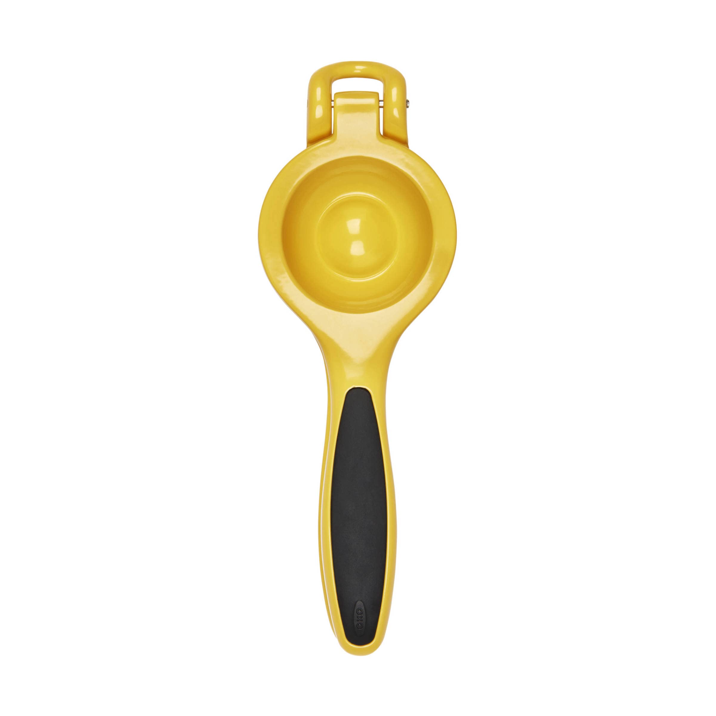 OXO Good Grips citrus squeezer beside glass to show scale and precise pouring benefit