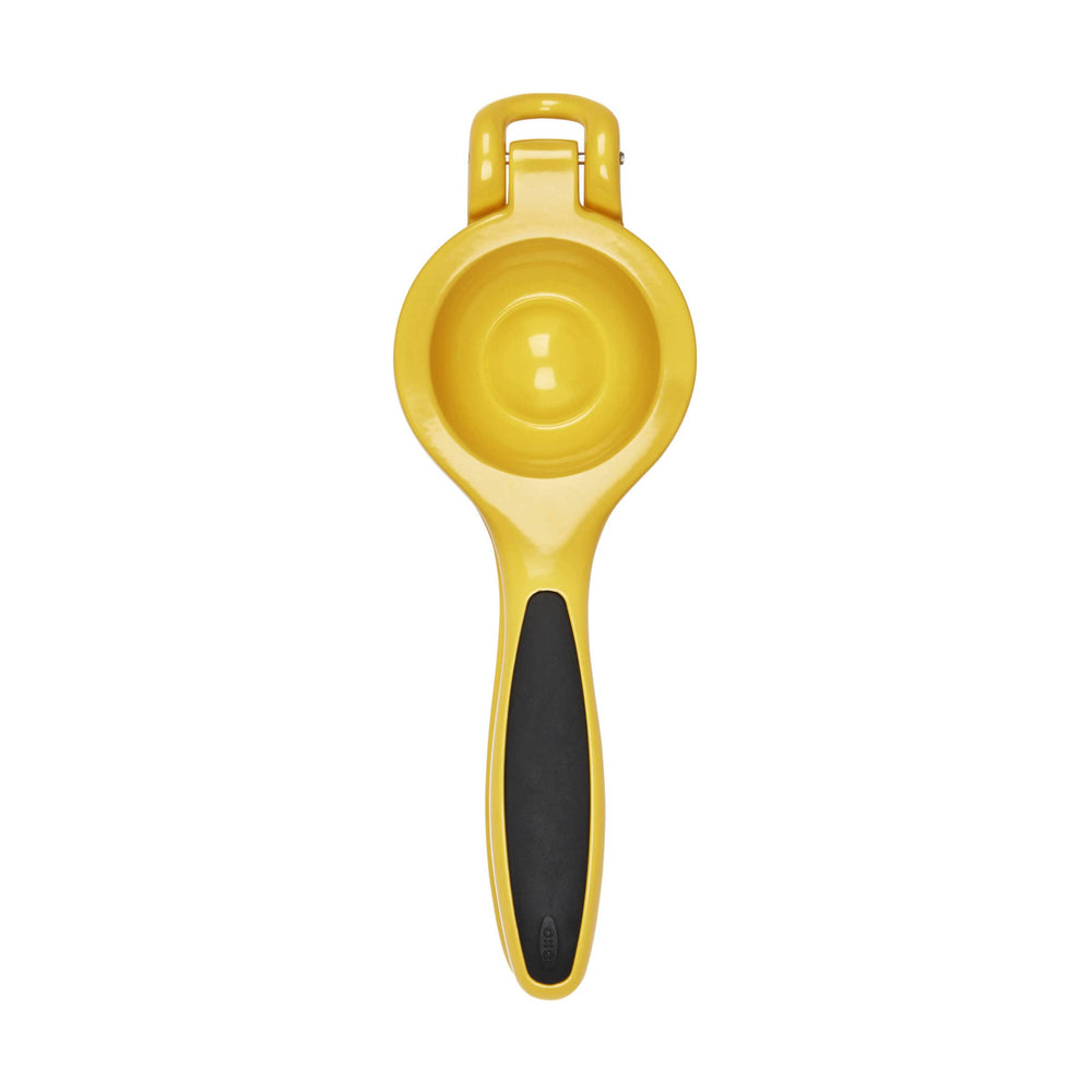 OXO Good Grips citrus squeezer beside glass to show scale and precise pouring benefit
