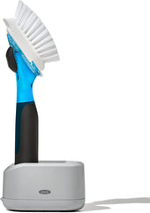 OXO Good Grips front view showing compact soap-dispensing brush and stand for tidy sink