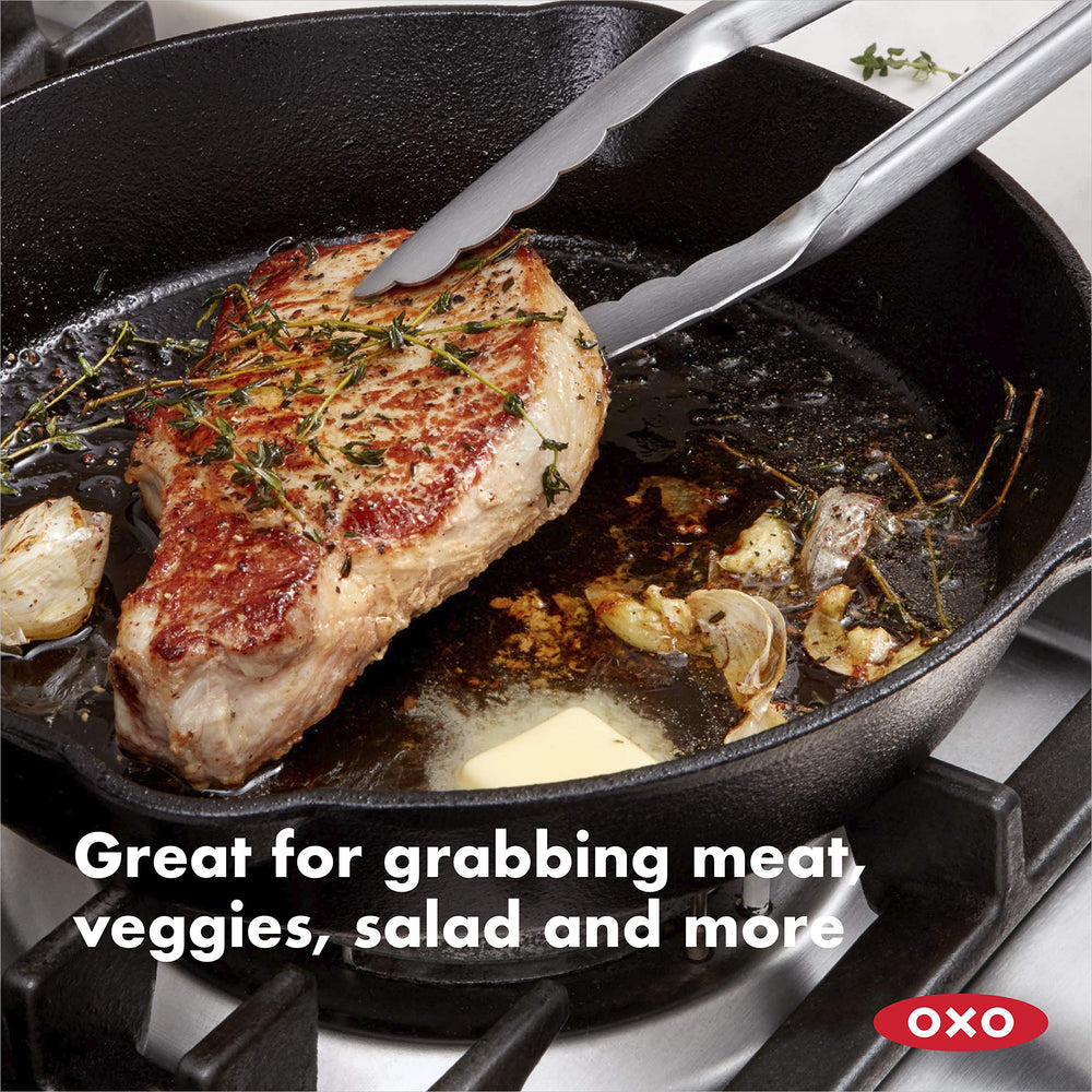 OXO Good Grips in use flipping steak showing heat-distance safety benefit