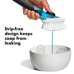 OXO close-up of non-slip handle and push-button delivering controlled soap for easier cleaning