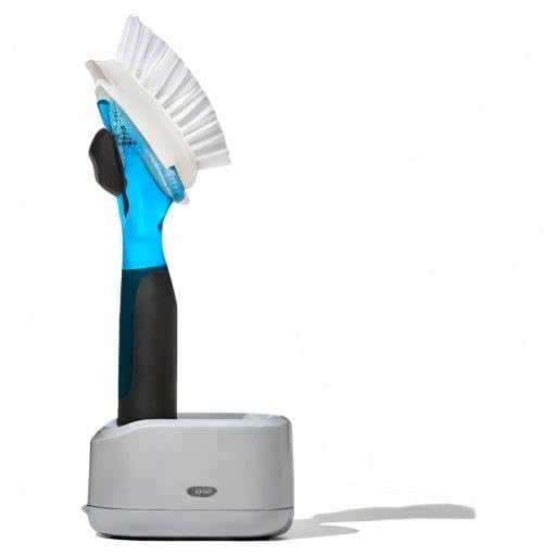 OXO brush in use cleaning a pan, providing targeted soap and effective scrubbing