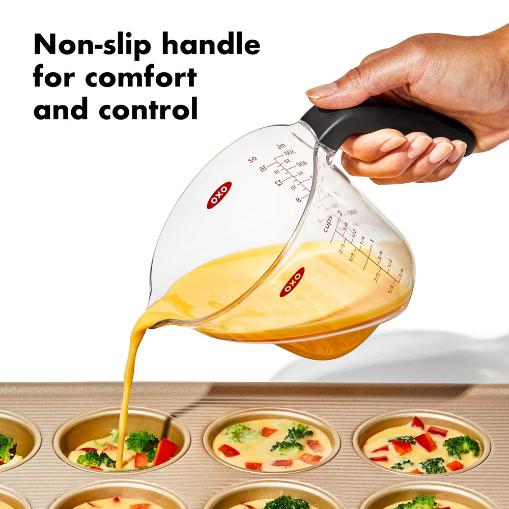 OXO pouring spout in use showing controlled pour with fewer drips