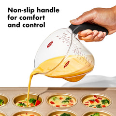 OXO pouring spout in use showing controlled pour with fewer drips