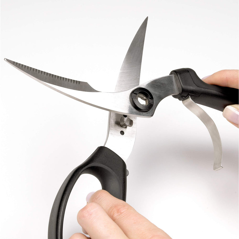 OXO shears held next to a hand to show scale and ergonomic fit for comfortable use