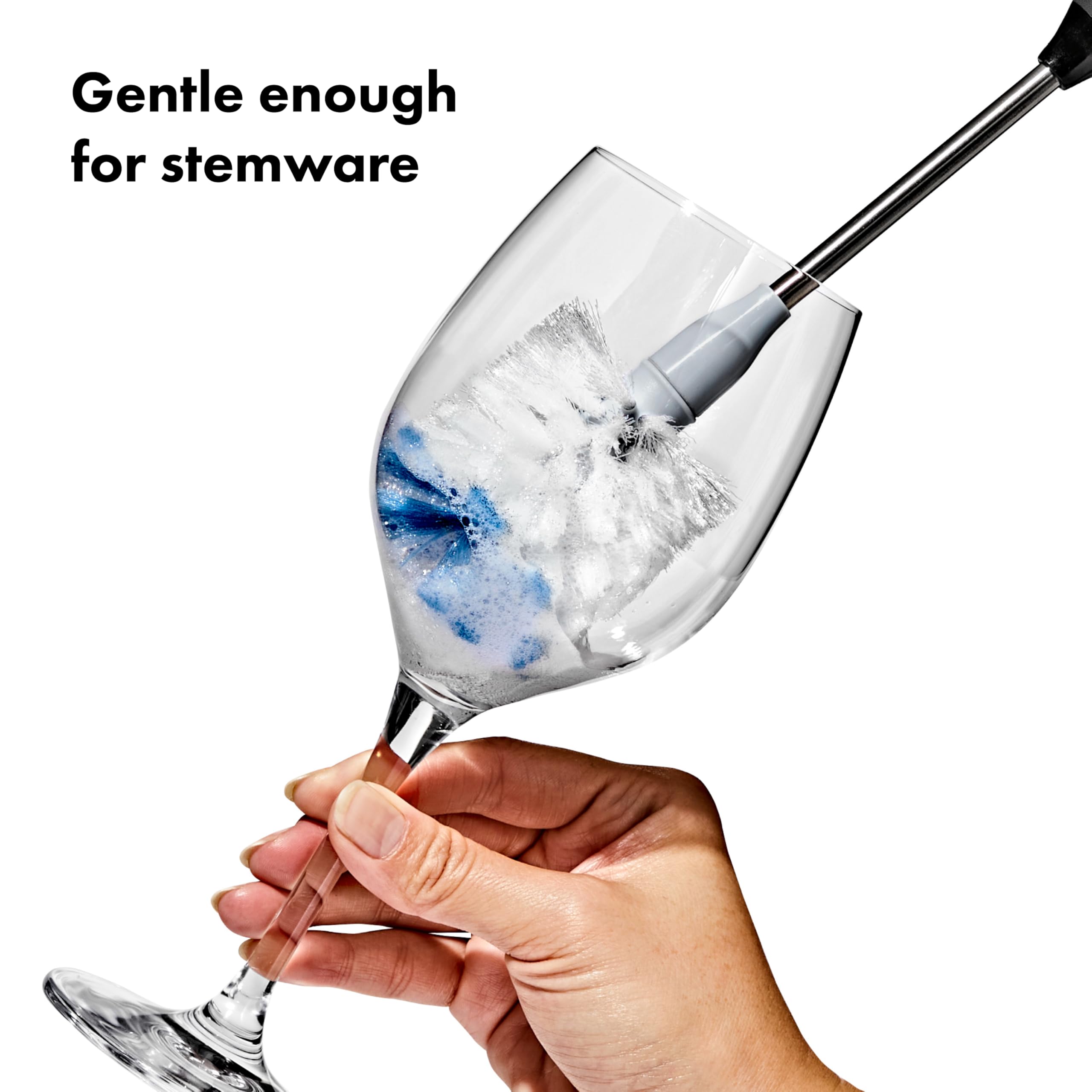 OXO brush next to spoon for size comparison shows compact reach and control