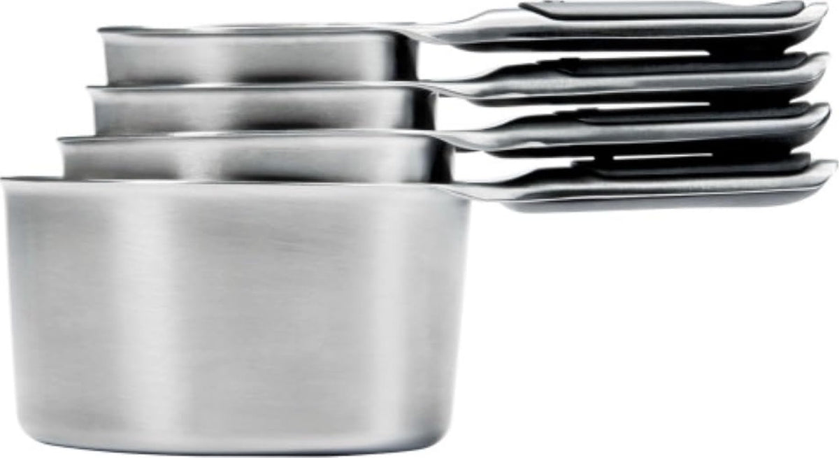 OXO Good Grips front view showing four stainless steel measuring cups and compact storage benefit