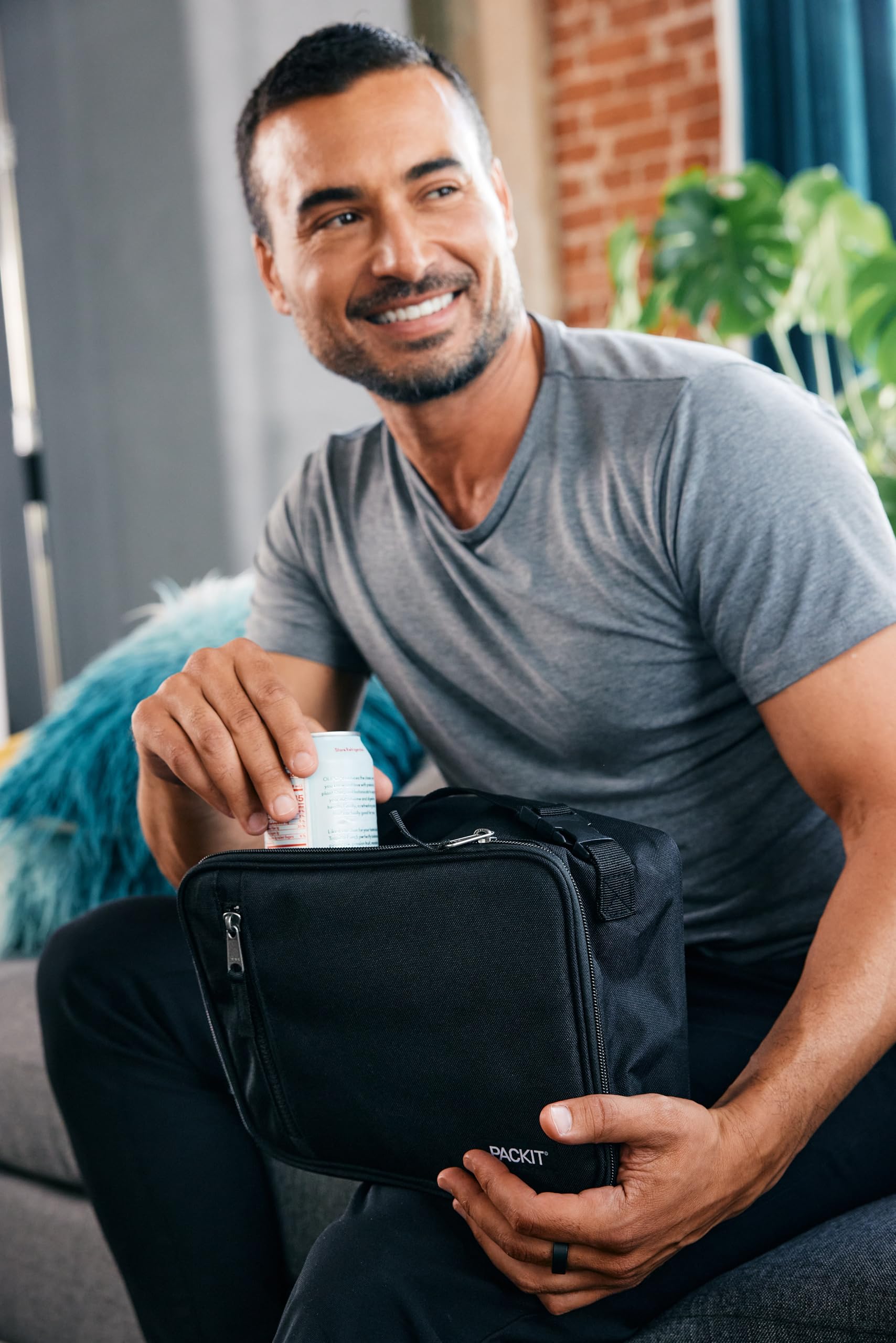 PackIt Classic attached to backpack buckle for secure on-the-go carrying