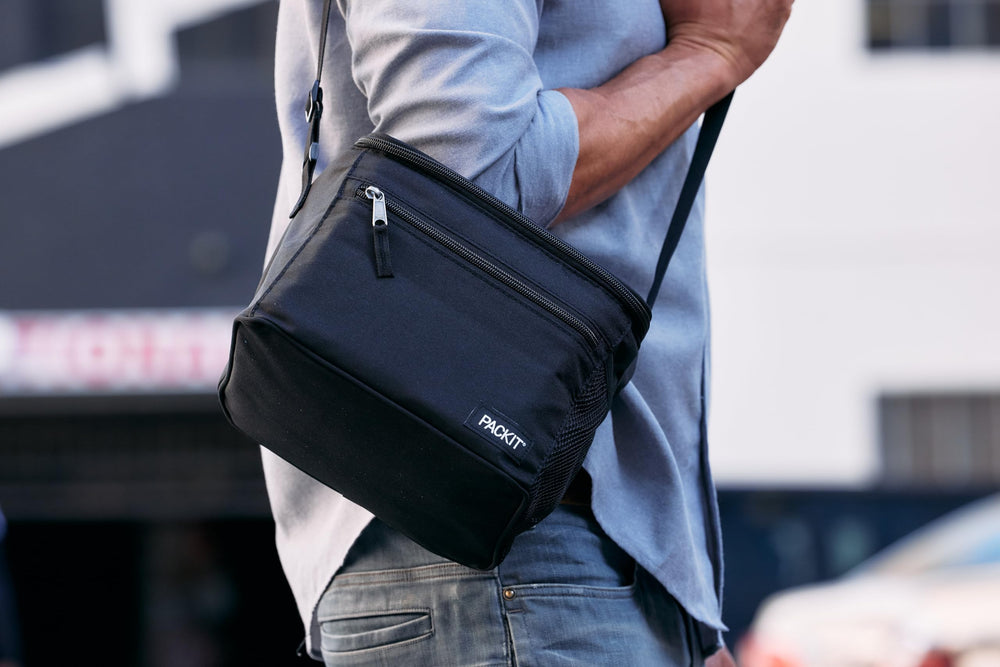 PackIt Essential cooler on an office desk with food inside illustrating portability and lunchtime convenience