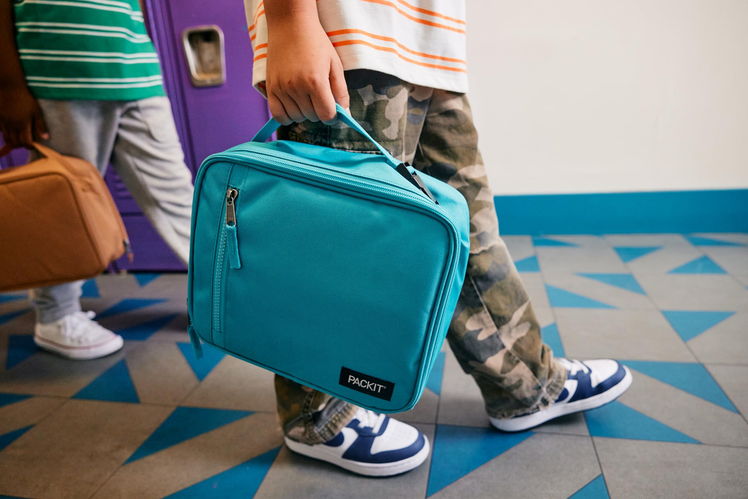 PackIt next to a water bottle showing scale and portable size for everyday use