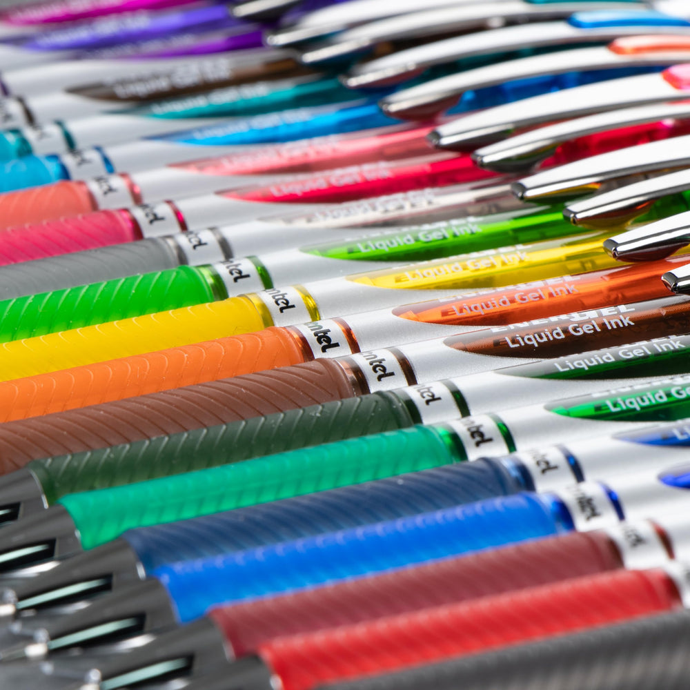 Pentel EnerGel RTX on a desk next to notebook showing reliable everyday writing benefit