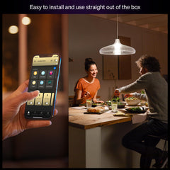 Philips Hue bulb installed in living room lamp showing warm cozy light