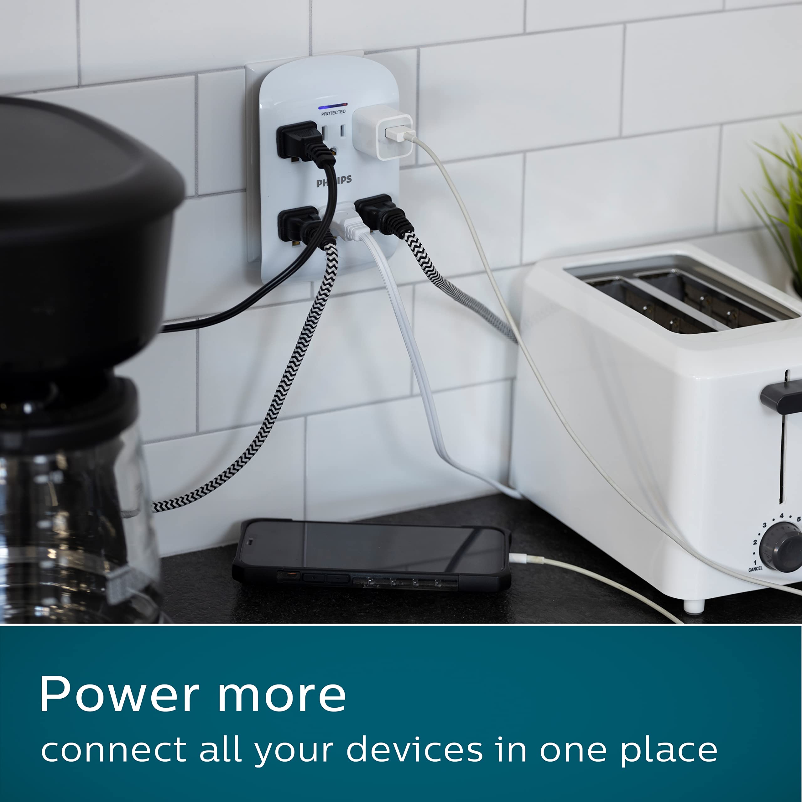 Philips wall tap in a desk lifestyle scene powering lamps and chargers