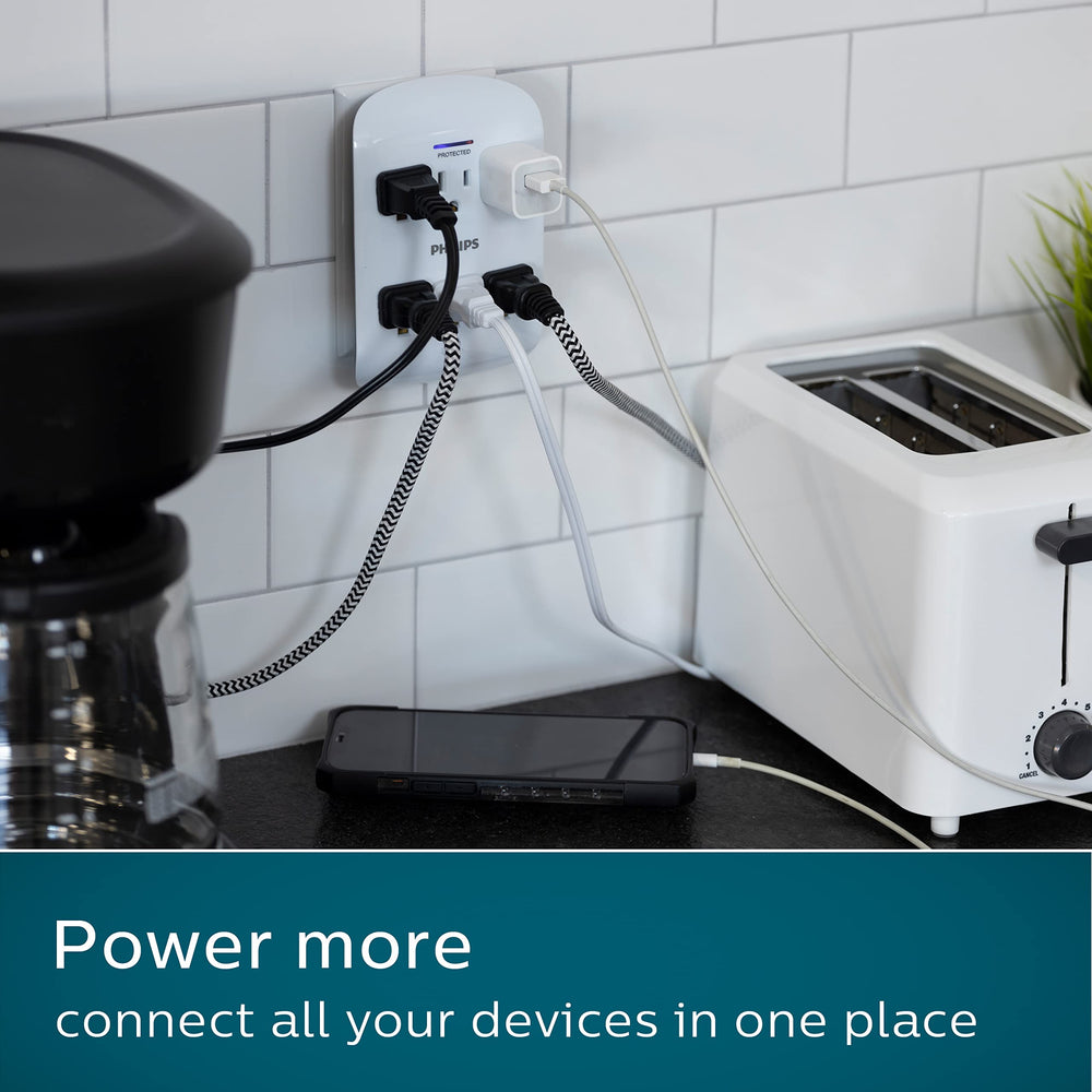 Philips wall tap in a desk lifestyle scene powering lamps and chargers