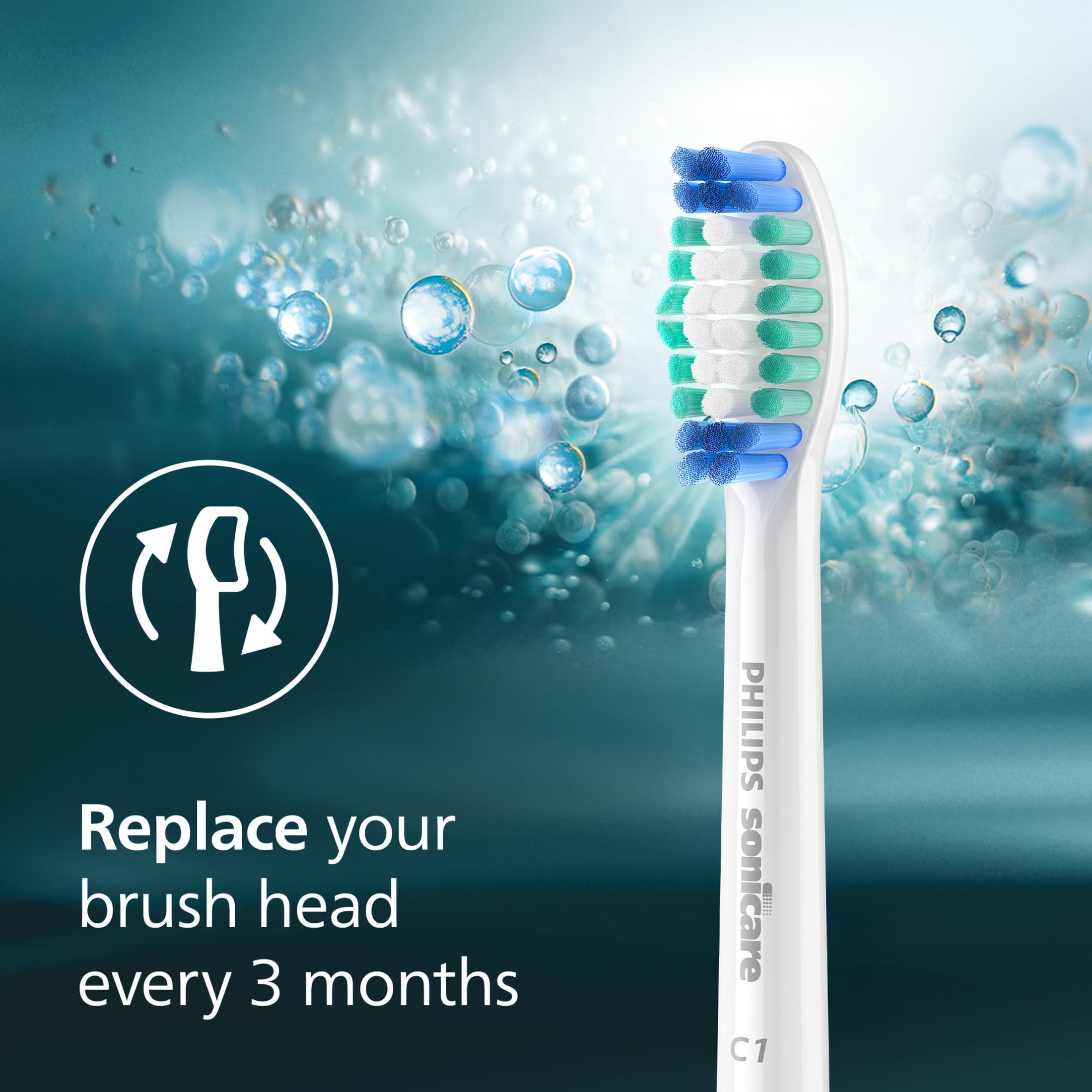 Philips Sonicare brush head beside a coin to show compact size and scale benefit