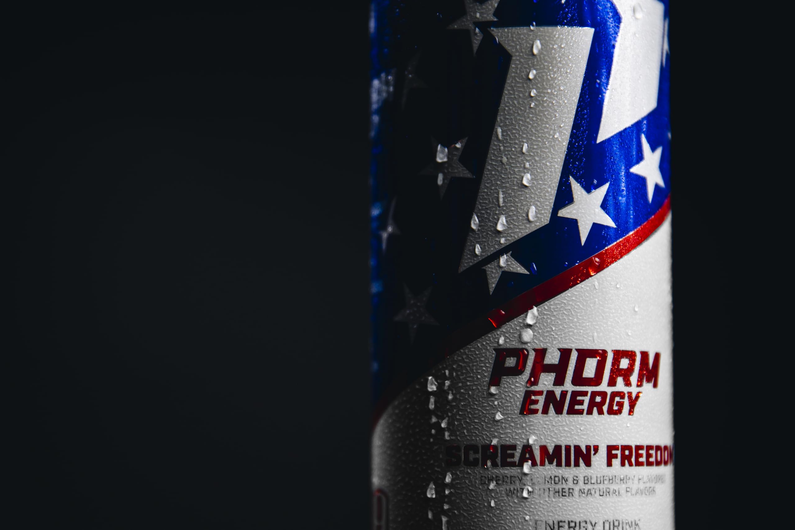 PHORM ENERGY can beside dumbbells and towel showing workout pairing benefits