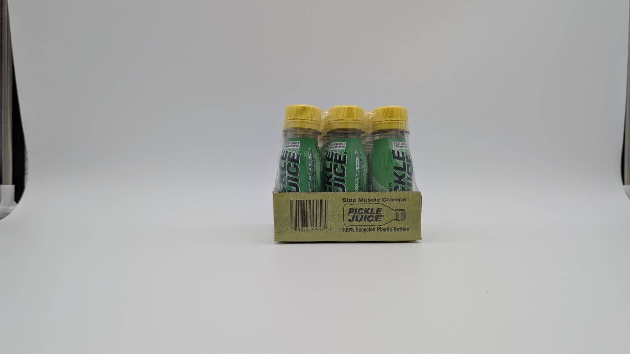 Pickle Juice shot open top pouring into hand for quick relief