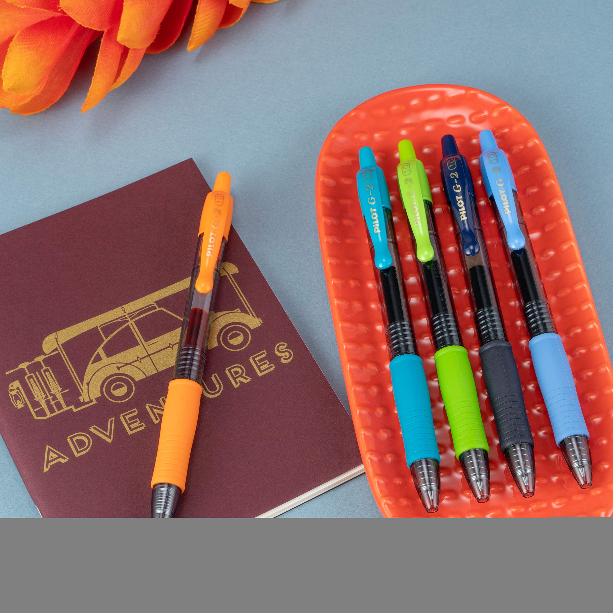 PILOT G2 pen next to hand for scale demonstrating ergonomic size