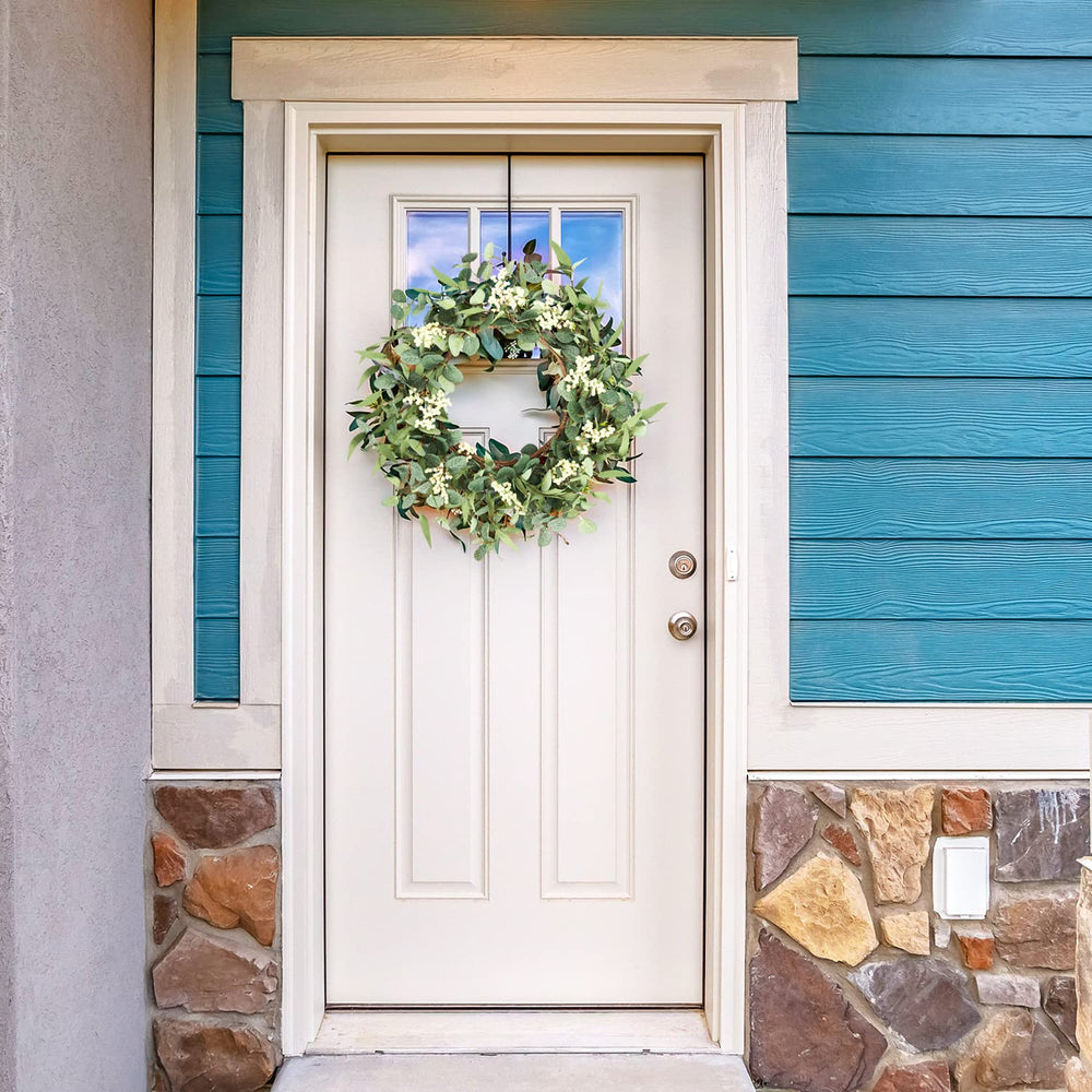 pinkpum wreath beside a door for scale showing its true 20-inch size