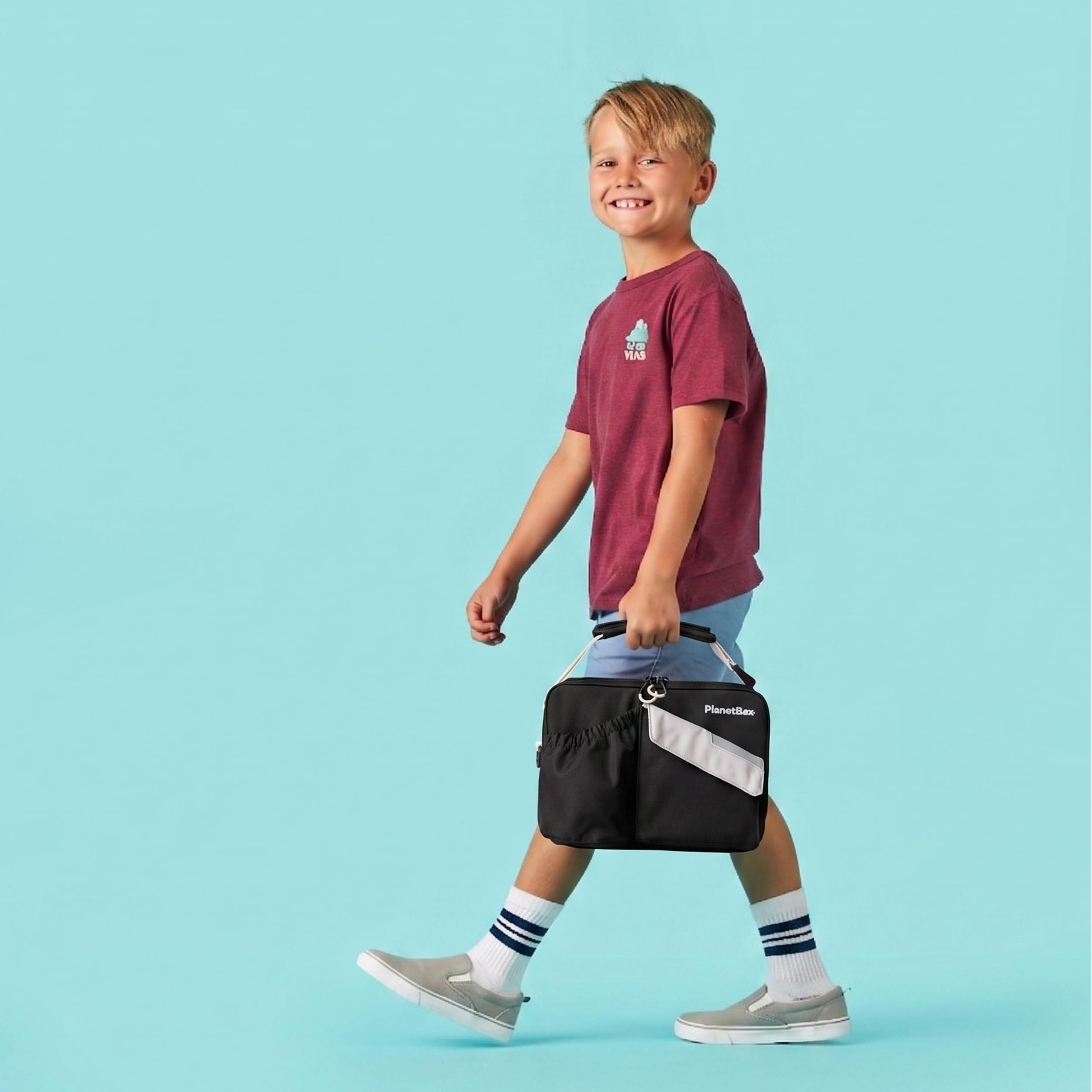 PlanetBox interior with elastic utensil straps and mesh pocket for organized packing benefits